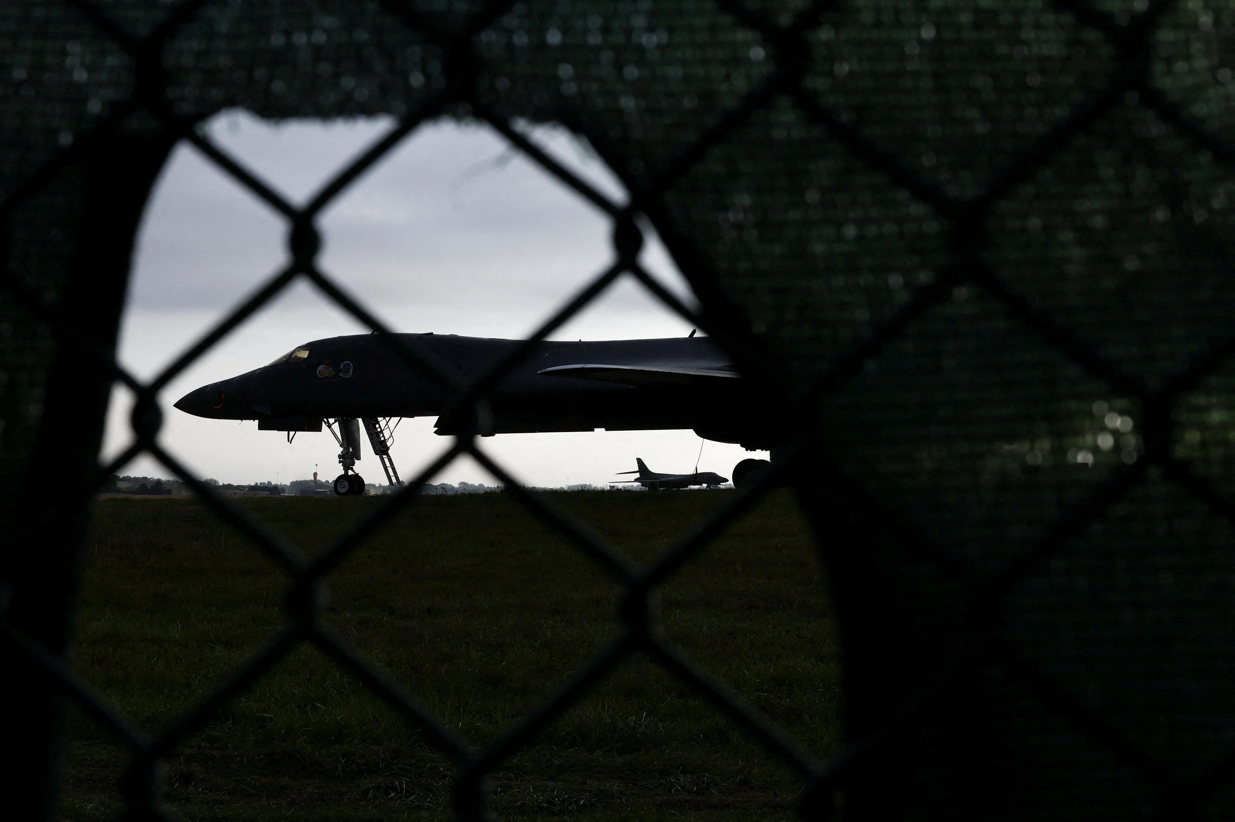 US Moves Bombers From UK Base After Security Fears US Moves Bombers From UK Base After Security Fears The United States has removed its B1 bombers from a British air base after security concerns emerged around the facility. The move was reported on October 5, 2026, after several men were arrested in Britain over an alleged plot connected to the base. The bombers had been stationed at RAF Fairford in Gloucestershire. The base is an important location for US military operations in Europe and has hosted American aircraft for many years. The decision to move the aircraft comes after British authorities arrested five men. Investigators are examining whether the suspects had been involved in activities connected to the American military presence. The arrests have raised questions about the security of US forces in Britain. American aircraft at British bases can be important during military operations involving Europe and the Middle East. Any security threat can therefore have wider consequences. The B1 is a long range bomber capable of carrying large amounts of weapons. It has been used by the United States in several military operations. Its presence in Britain also allows Washington to move aircraft closer to areas where they may be needed. The United States and Britain have a close defense relationship. Both countries are members of NATO and regularly conduct military exercises. American forces have access to several British facilities, making cooperation between the two countries an important part of European security. The removal of the bombers does not mean the United States is ending its military relationship with Britain. It is instead a security measure following the arrests. British investigators are still examining the alleged plot. The suspects have not been found guilty, and the full details of the case have not yet been established in court. The investigation comes during a period of high tension in the Middle East. The United States has military forces operating in and around the region as Washington deals with Iran and other security threats. American officials must therefore consider several risks at the same time. A base in Britain may appear far from the Middle East, but it can still become a target because of its role in US military operations. The move also shows how foreign military facilities can become part of wider security disputes. Britain hosts several American forces, and those bases have strategic value for both countries. Local communities near RAF Fairford are familiar with the presence of US aircraft. The base has been used for exercises and operations for decades. Security measures are often increased when major military events take place. The latest decision could lead to further reviews of security around the base. British and American officials will want to know whether the alleged suspects acted alone or had wider links. The case may also affect future US deployments. Washington could decide to use different bases or increase protection at existing facilities. For Britain, the situation creates a difficult balance. The country wants to remain a close US military partner while ensuring that foreign forces operating from British soil do not create unacceptable security risks. The October 5 report shows how quickly a domestic security case can affect international military planning. The B1 bombers may return after the security situation is reviewed. For now, their removal is a sign that American officials are taking the threat seriously. The investigation remains active, and more information is expected as British authorities continue examining the alleged plot and any possible links to Iran or other actors.